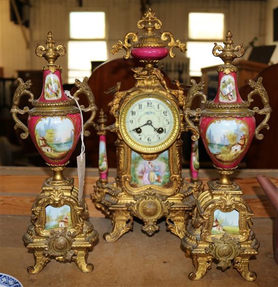 A French gilt metal and Sevres style porcelain mantel clock garniture, 16in.